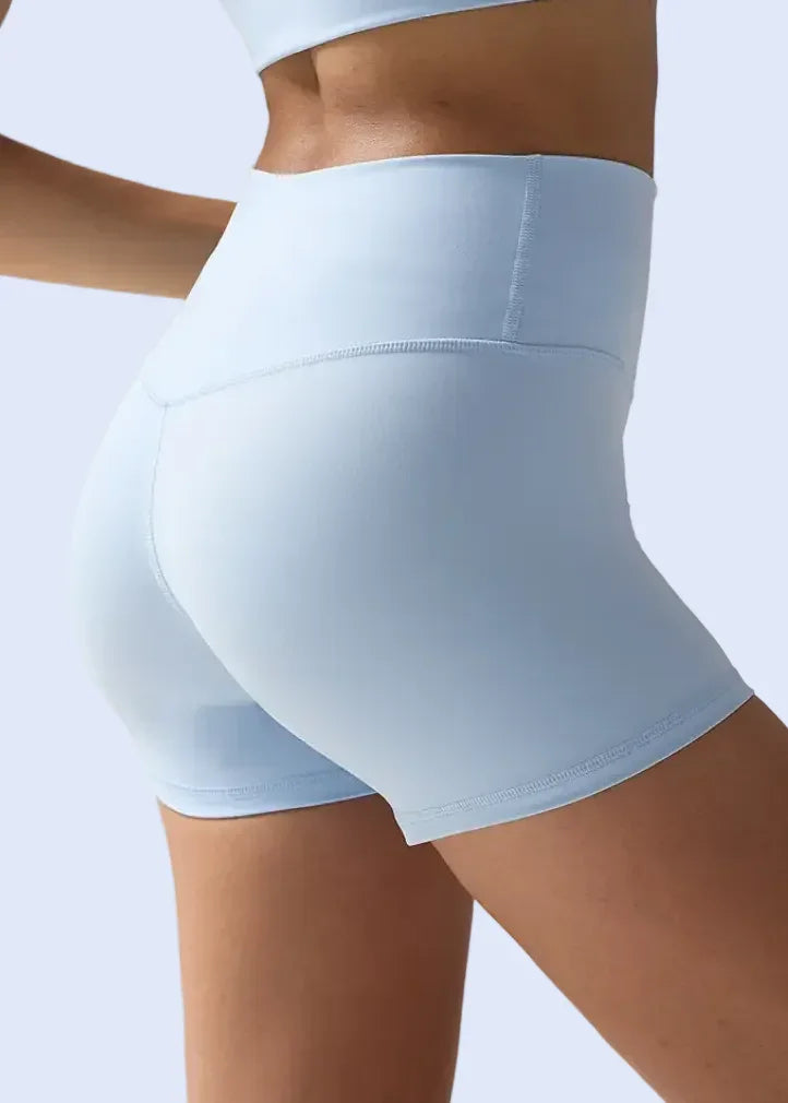 Light blue athletic shorts worn by a person on a plain background