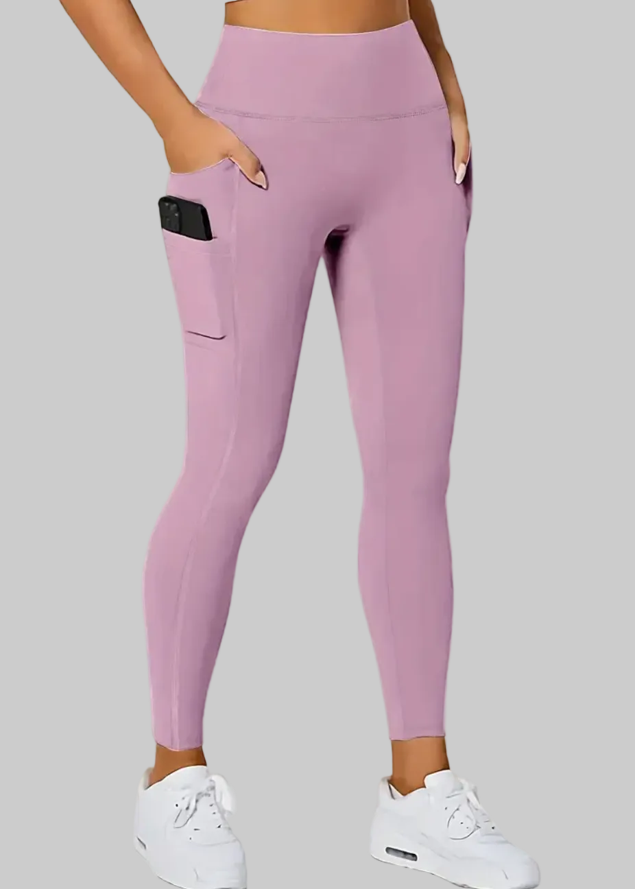 Person wearing pink leggings with a plain background