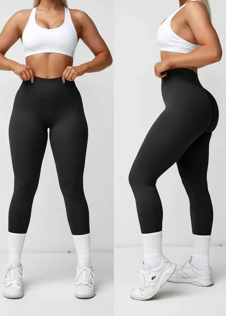 Woman squatting in black high-waisted leggings, white sports bra, and sneakers, GymDeity activewear
