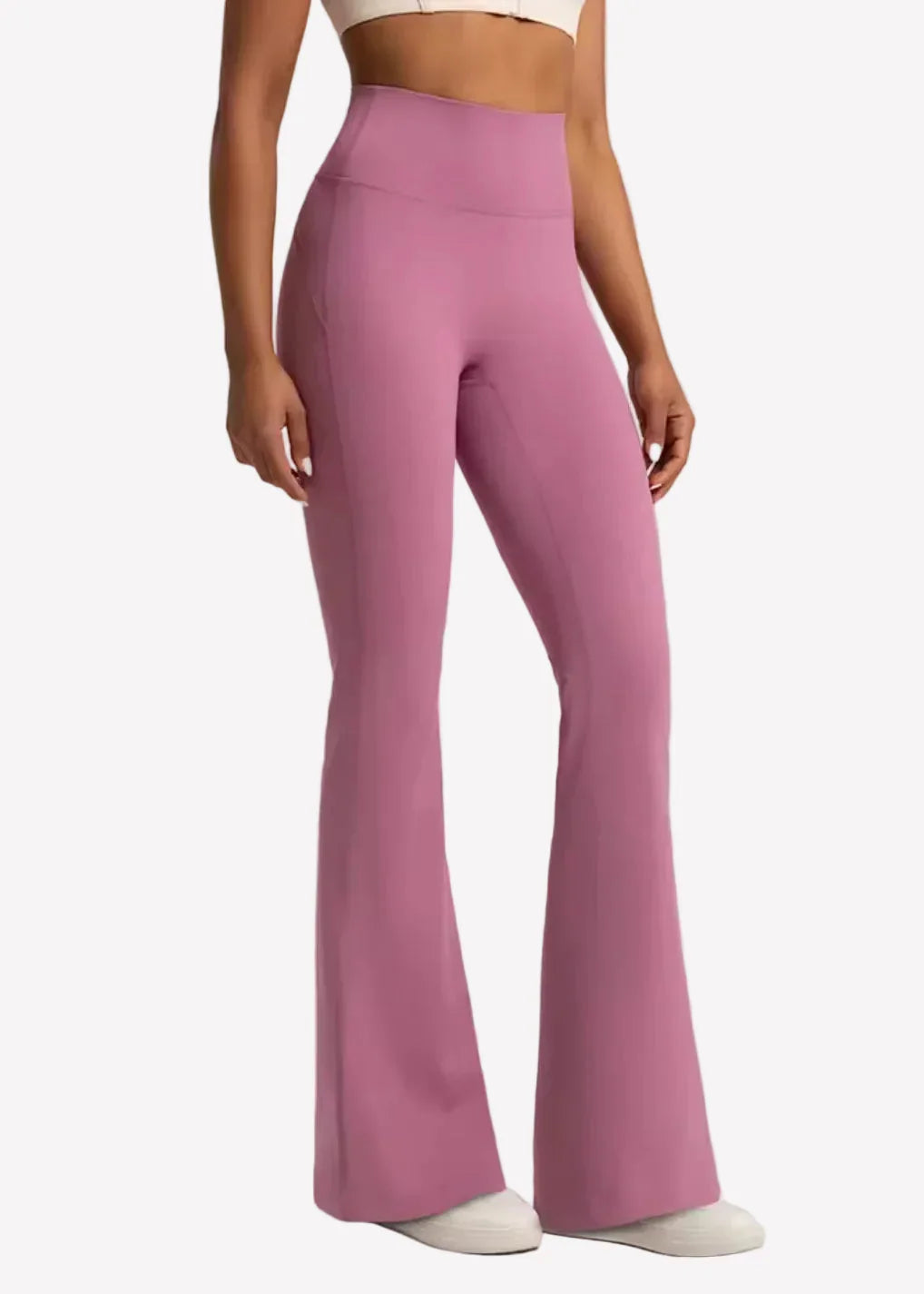 Woman modeling high-waisted pink flare yoga pants, affordable activewear by GymDeity