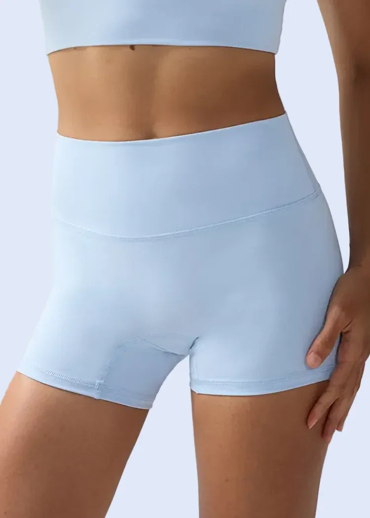 Light blue athletic shorts worn by a person on a plain background