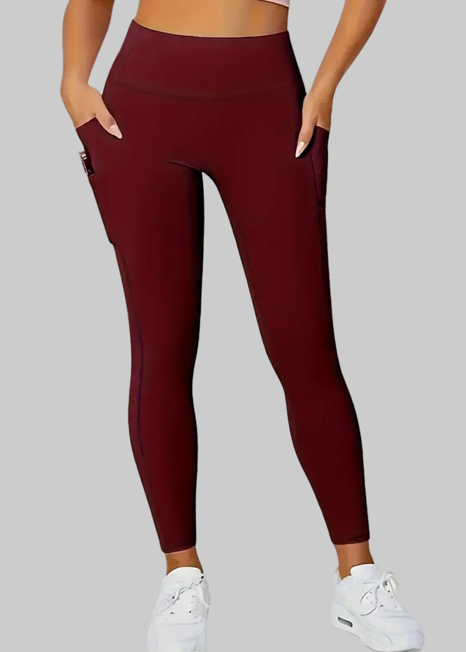 Maroon leggings worn by a person on a beige background