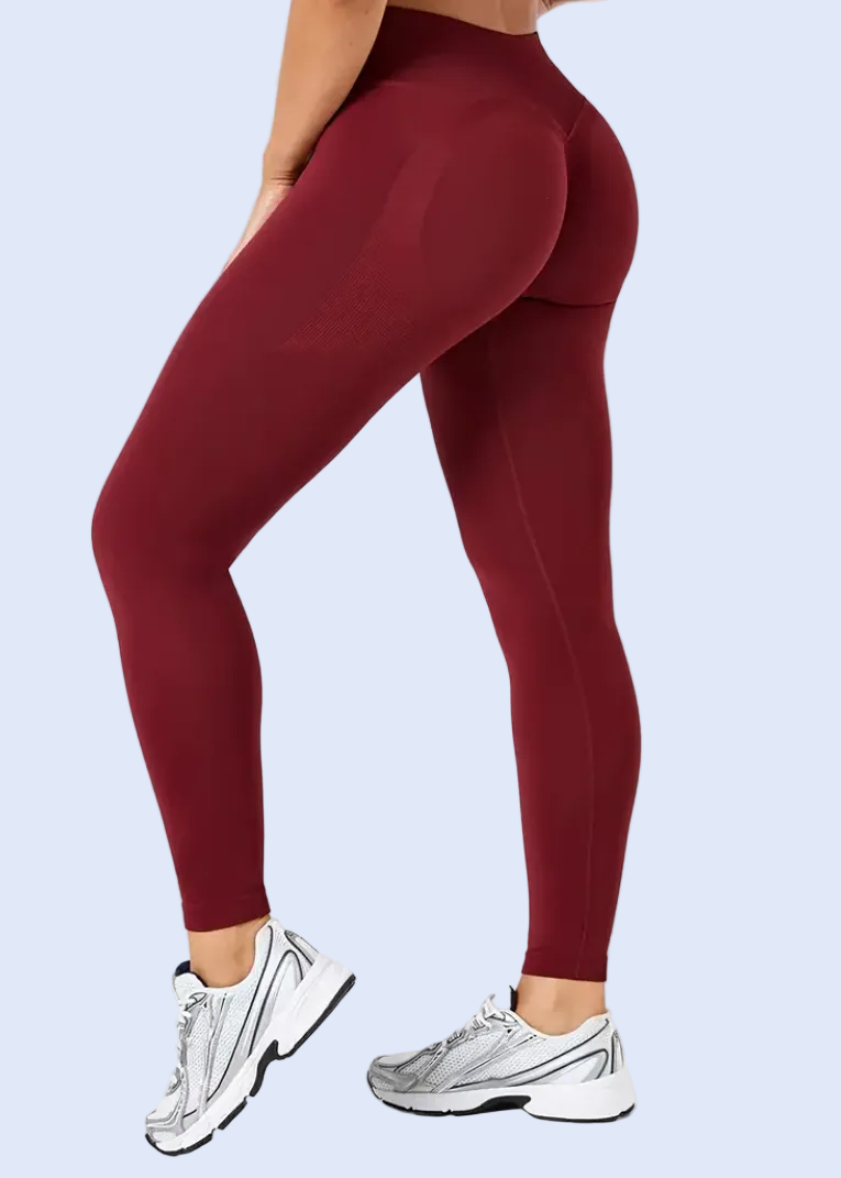 Maroon leggings worn by a person on a white background