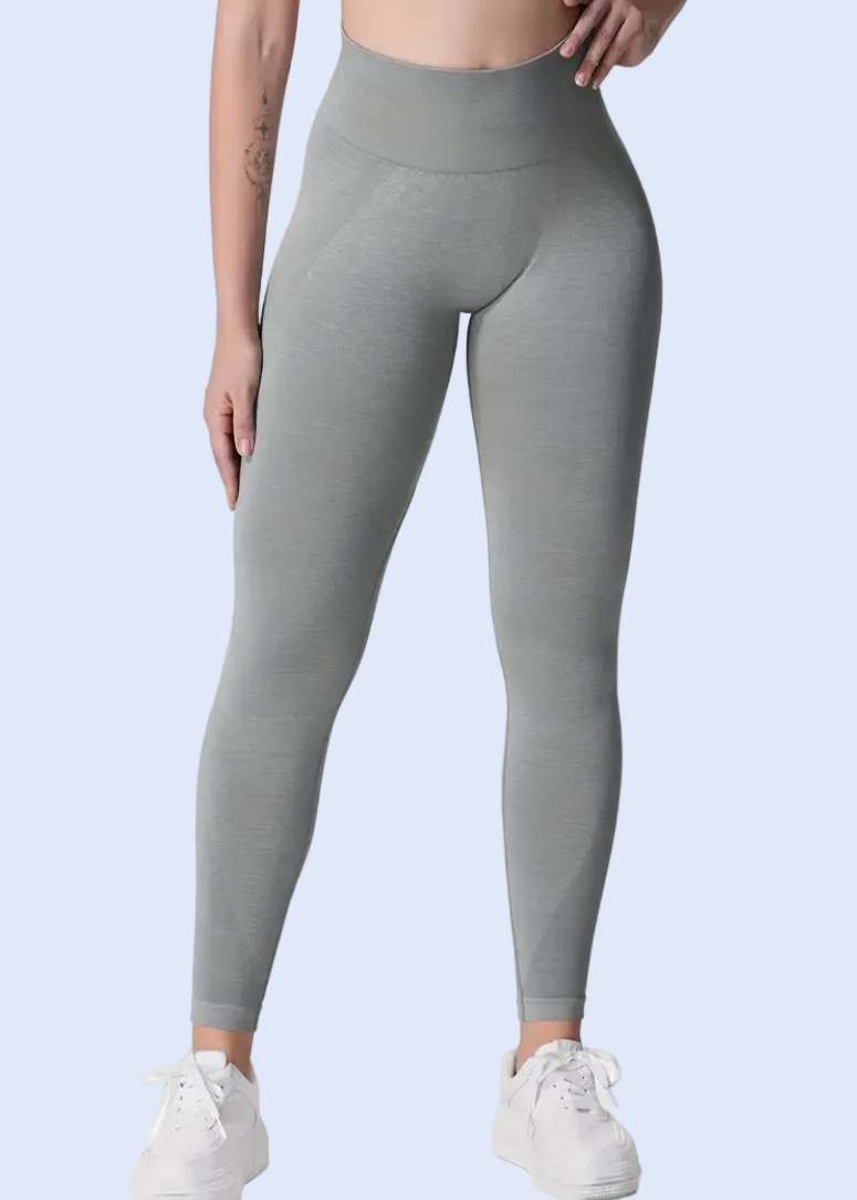 Person wearing gray leggings on a white background