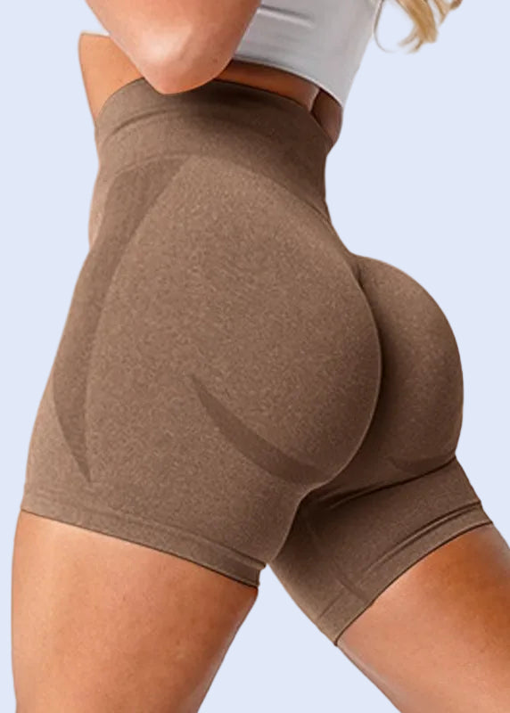 Brown shorts worn by a person on a white background