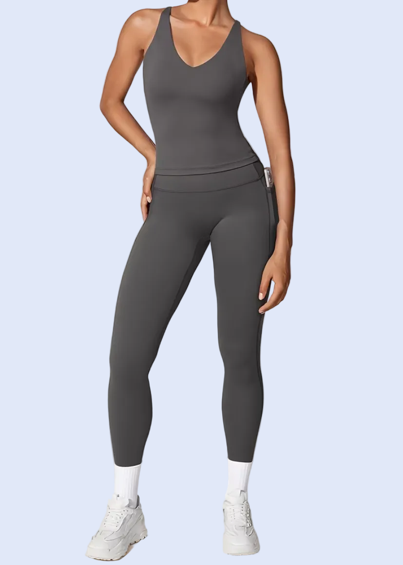 Person wearing a gray jumpsuit on a white background