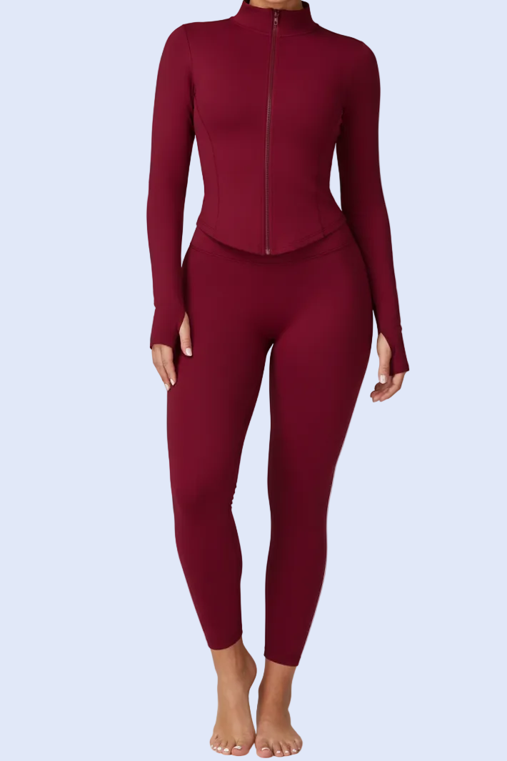 Maroon tracksuit worn by a model on a white background with product details at the bottom.