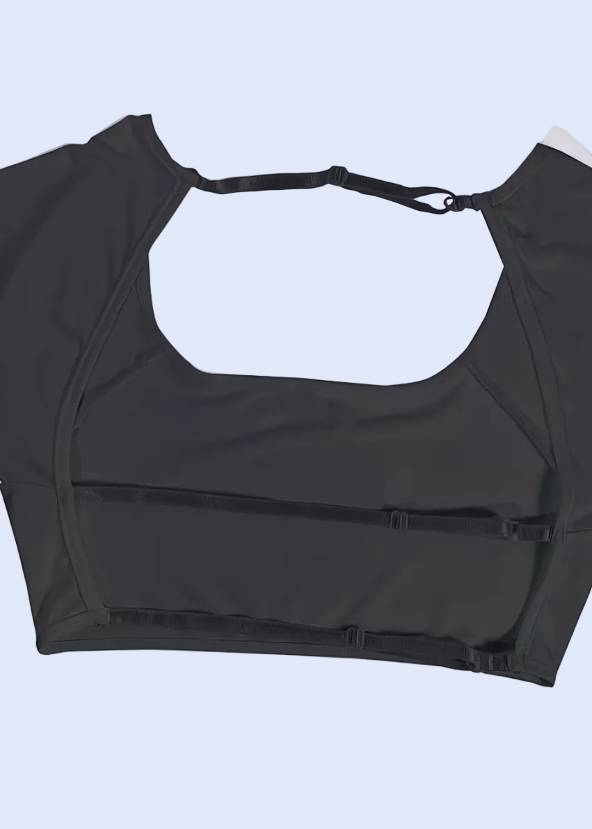 Black sports bra on a white background with a shopping cart icon at the bottom.