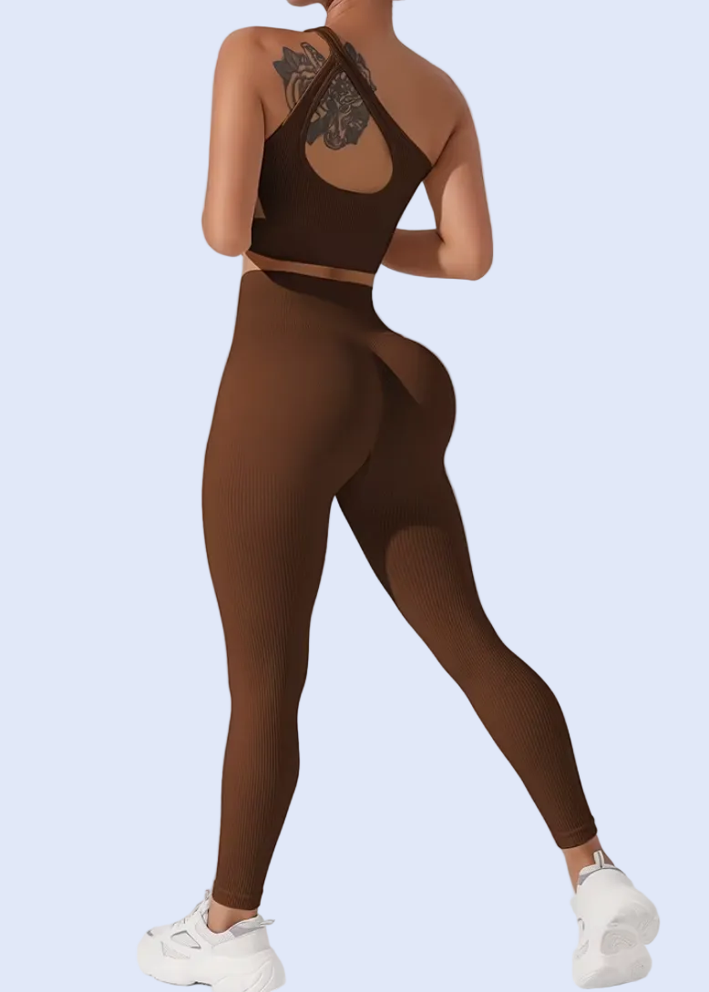 Person wearing a brown outfit with lace details on a white background