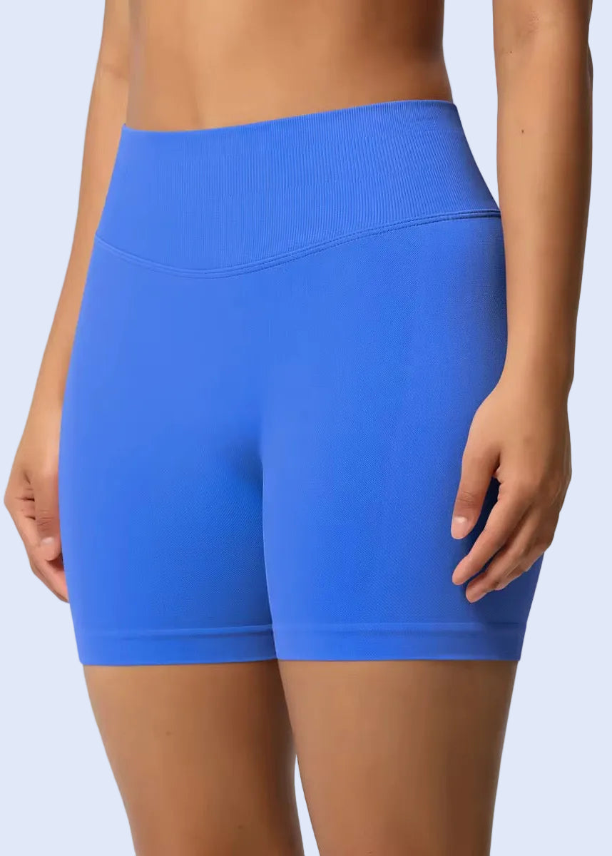 Blue athletic shorts worn by a person on a plain background