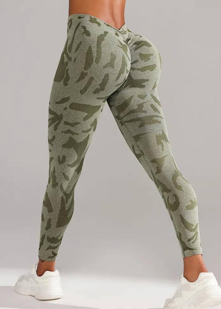 Camouflage jogger pants worn by a person on a gray background