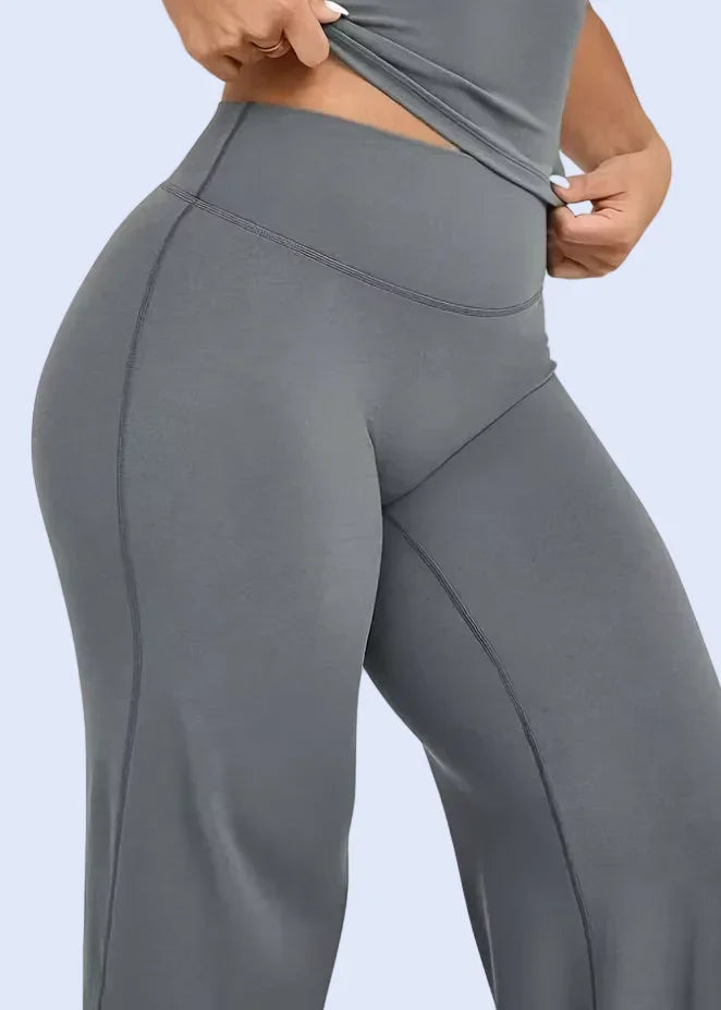 Gray leggings being worn on a white background