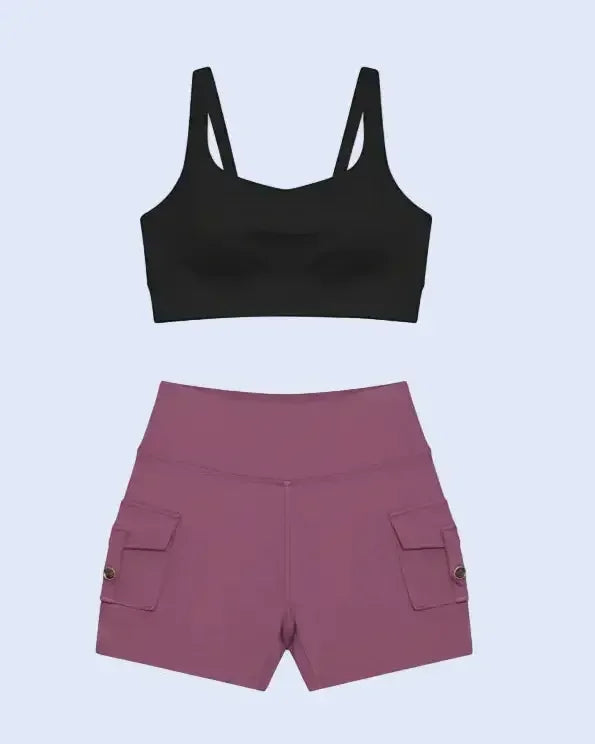 Black sports bra and maroon shorts on a light blue background