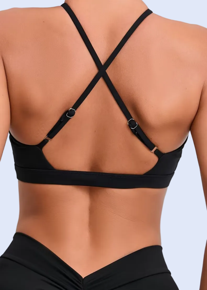 Black sports bra and leggings on a plain background