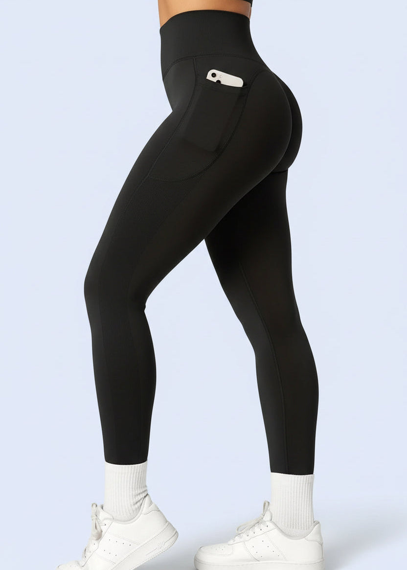 Woman in black high-waisted gym leggings with side pocket, affordable activewear from GymDeity