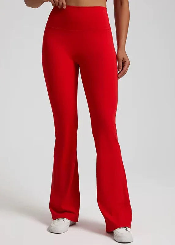 Woman wearing high-waisted red flared activewear pants from GymDeity