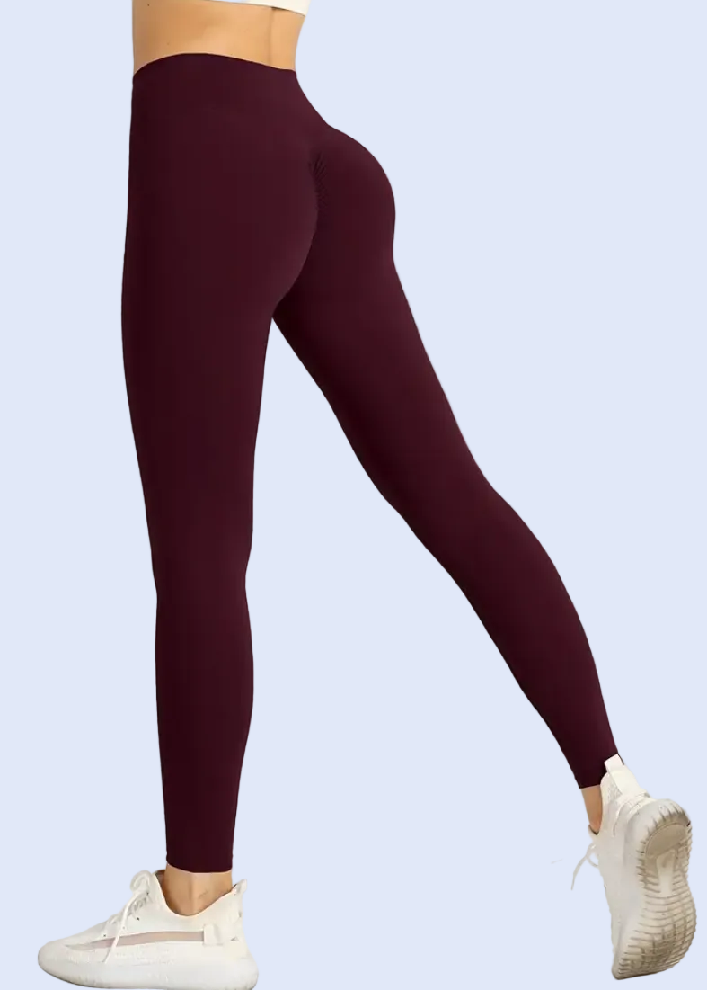 Maroon leggings worn by a person on a white background