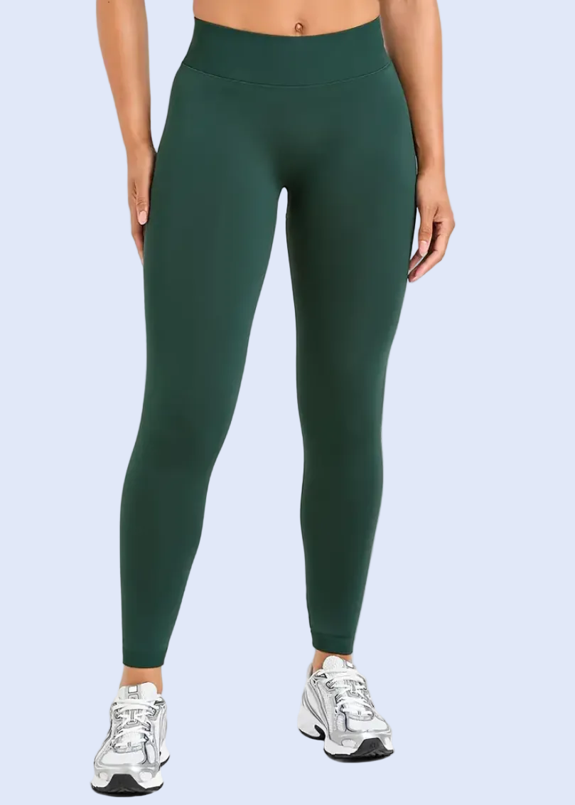Person wearing green leggings on a white background