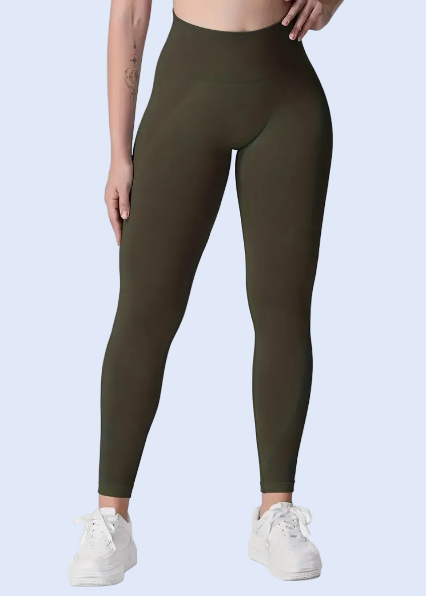 Person wearing olive green leggings on a white background