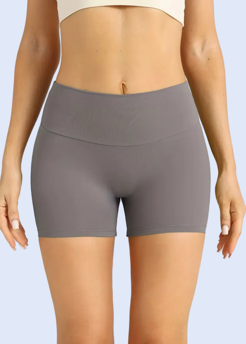 Gray shorts worn by a person on a plain background