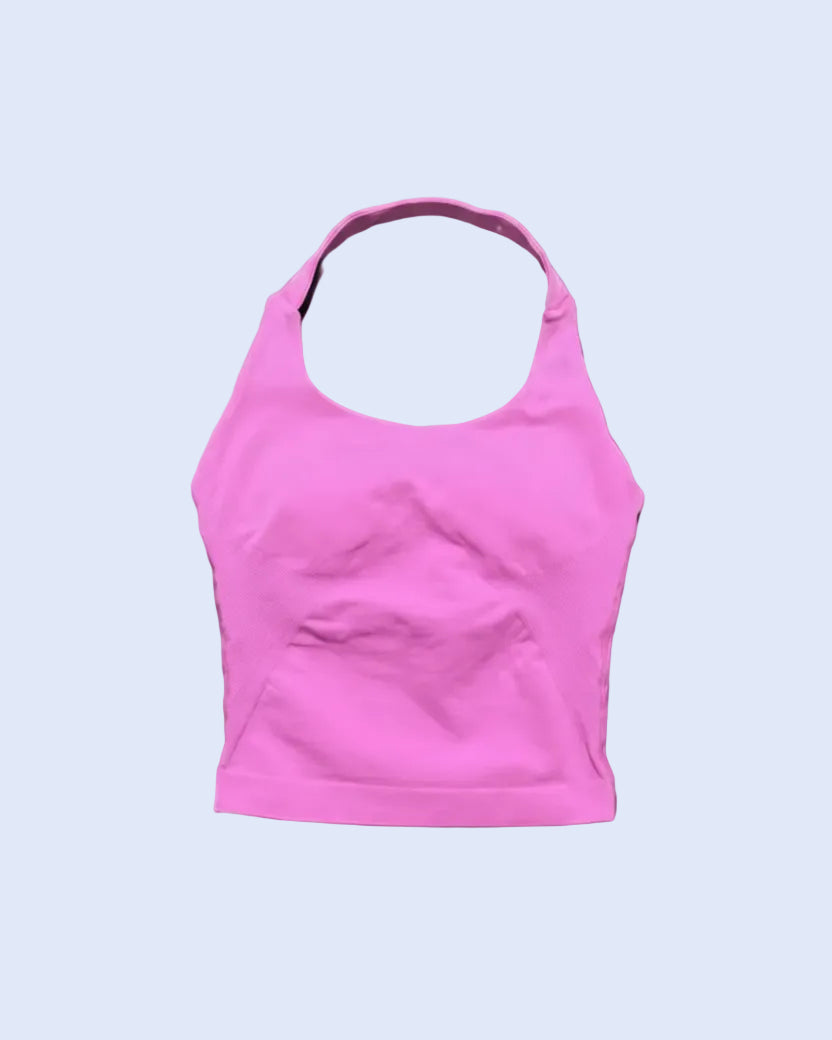A bright pink athletic sports bra with a scoop neckline and a small front pouch pocket, laid flat against a dark gray background.