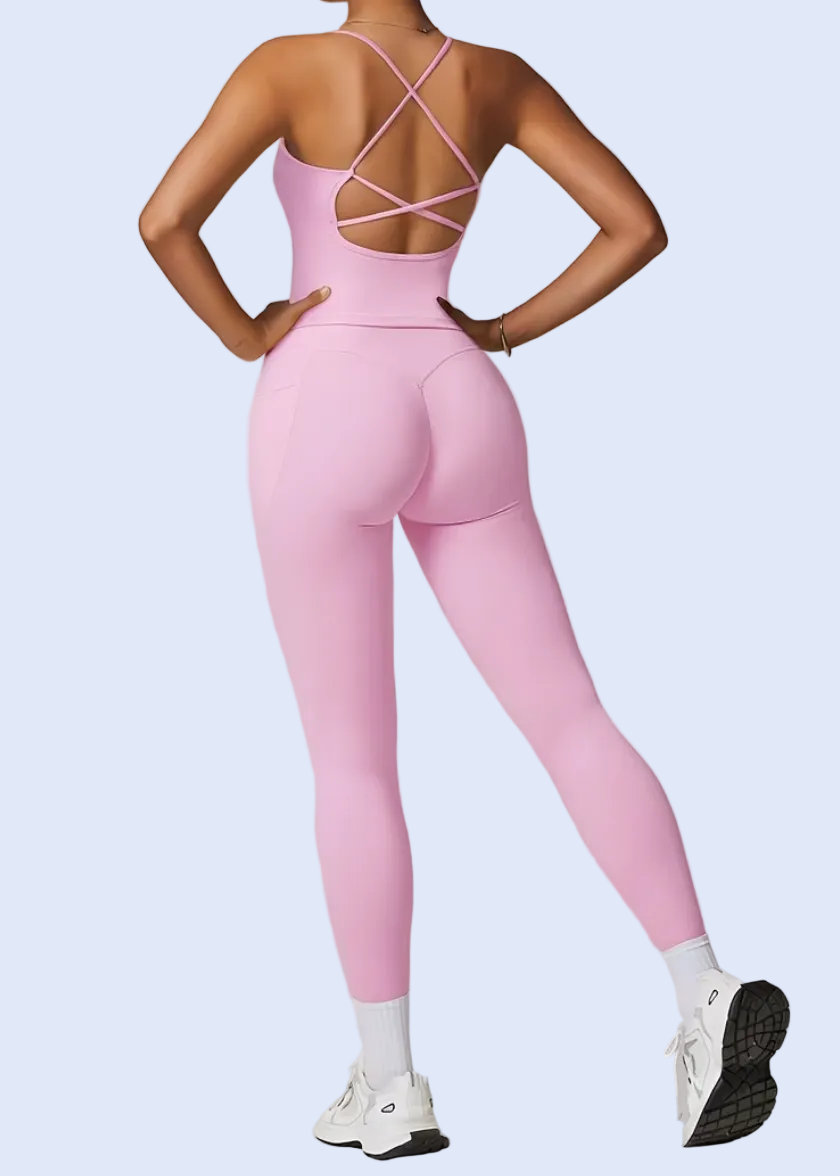 Person wearing a pink jumpsuit on a plain background