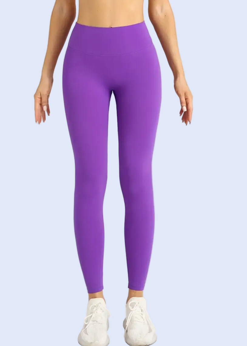 Person wearing purple leggings on a white background