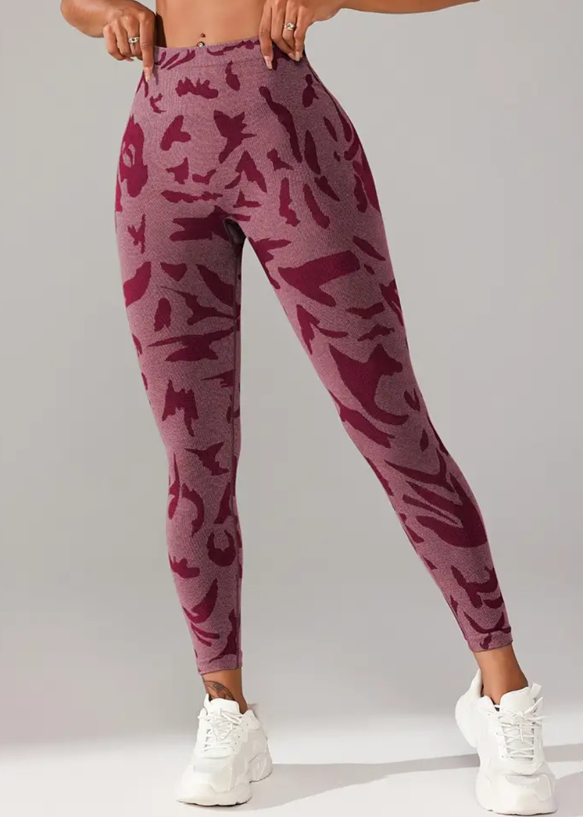 Person wearing maroon camouflage leggings on a gray background