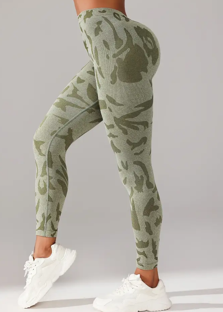 Person wearing green camouflage pants on a gray background