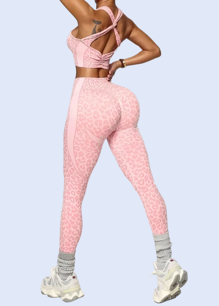 Person wearing a pink athletic outfit on a white background