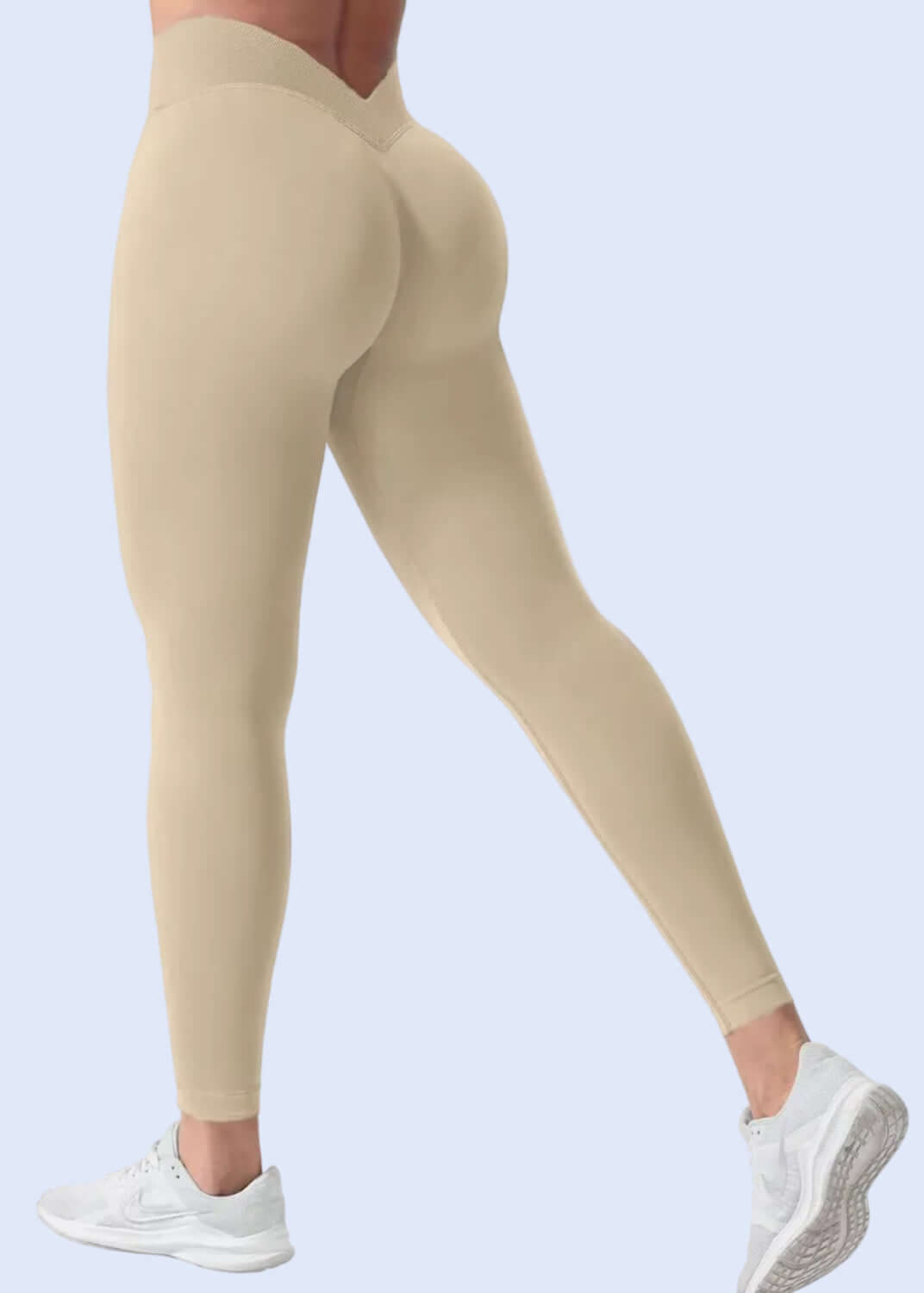 Beige leggings worn by a person on a white background