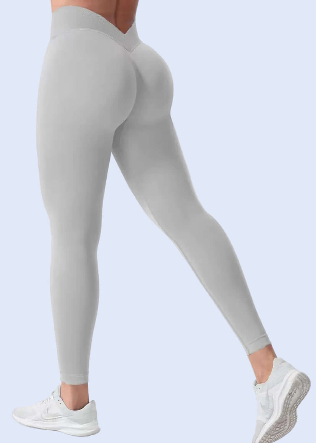 Gray leggings worn by a person on a white background