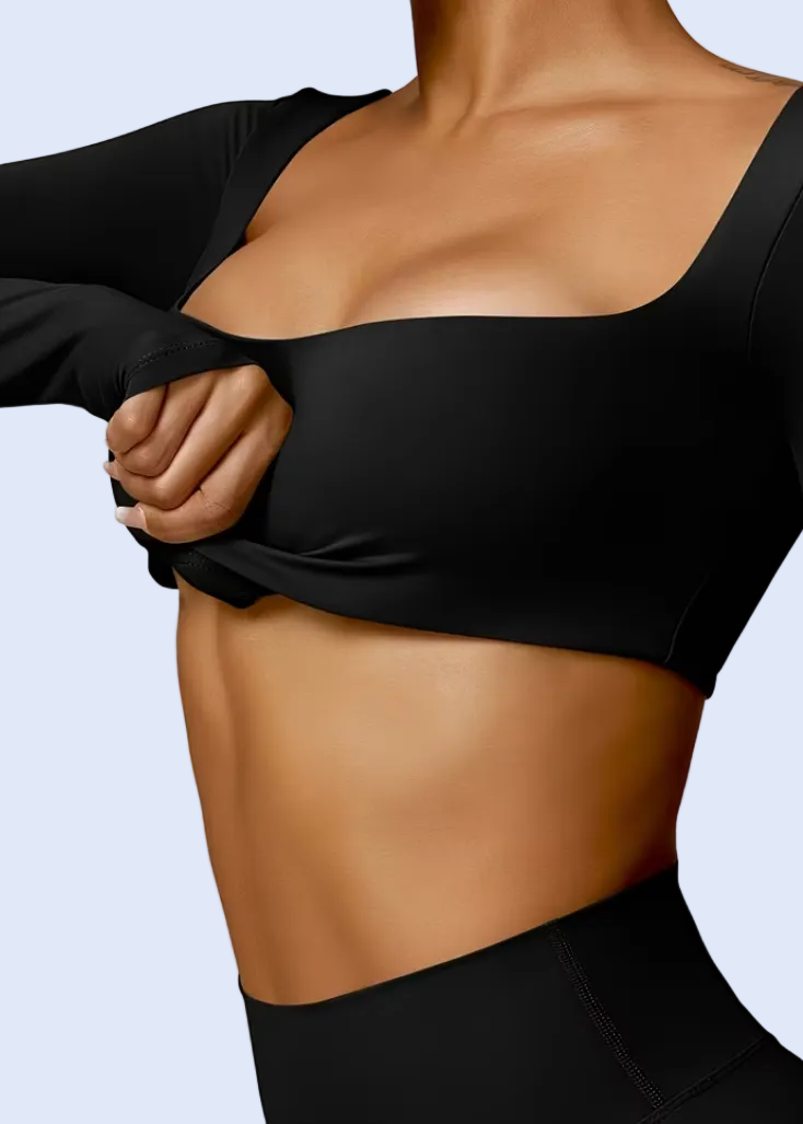 Person wearing a black athletic outfit on a plain background