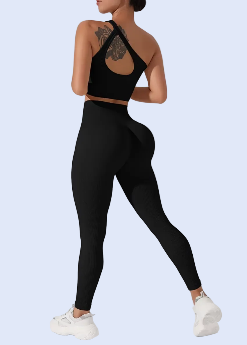 Person wearing a black sports bra and leggings on a white background