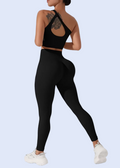 Person wearing a black sports bra and leggings on a white background