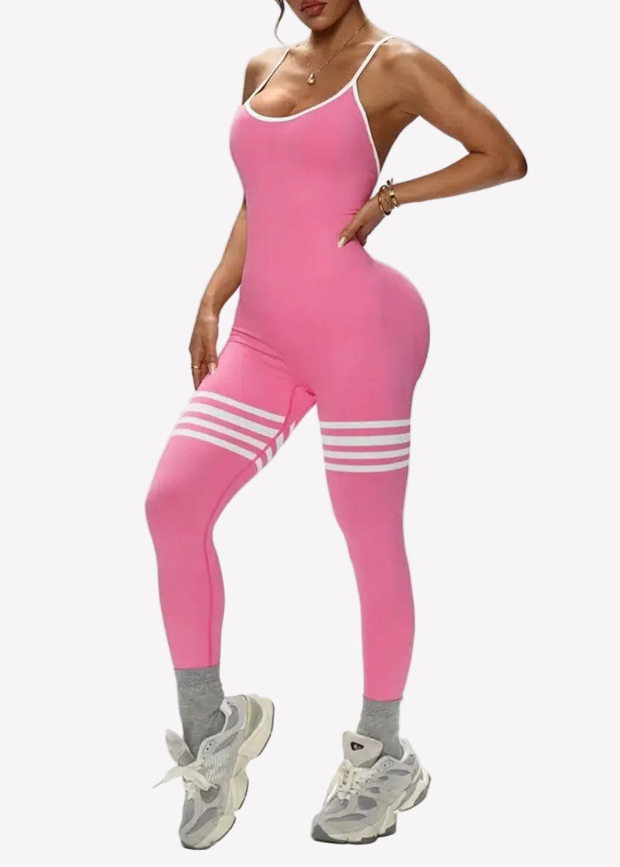 Person wearing a pink fitness jumpsuit on a plain background