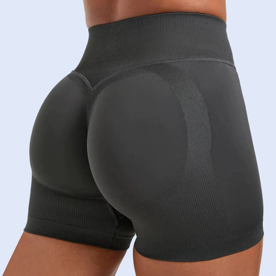 Black athletic shorts worn by a person on a white background