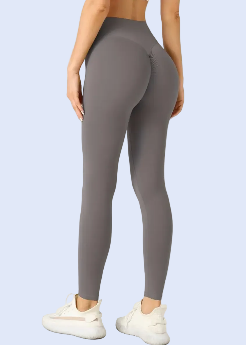 Person wearing gray leggings on a white background