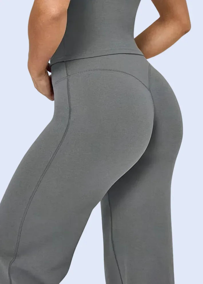 Gray leggings worn by a person on a white background
