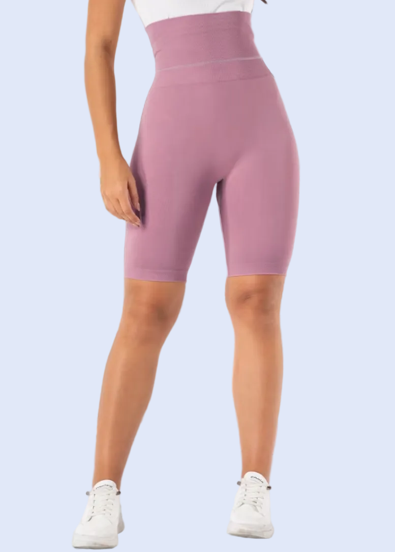 Person wearing pink high-waisted leggings in a kitchen setting