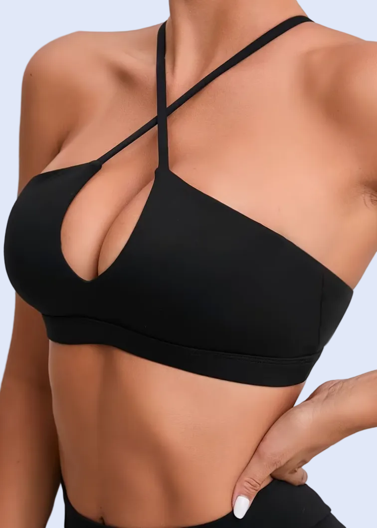 Black bikini top worn by a person on a plain background