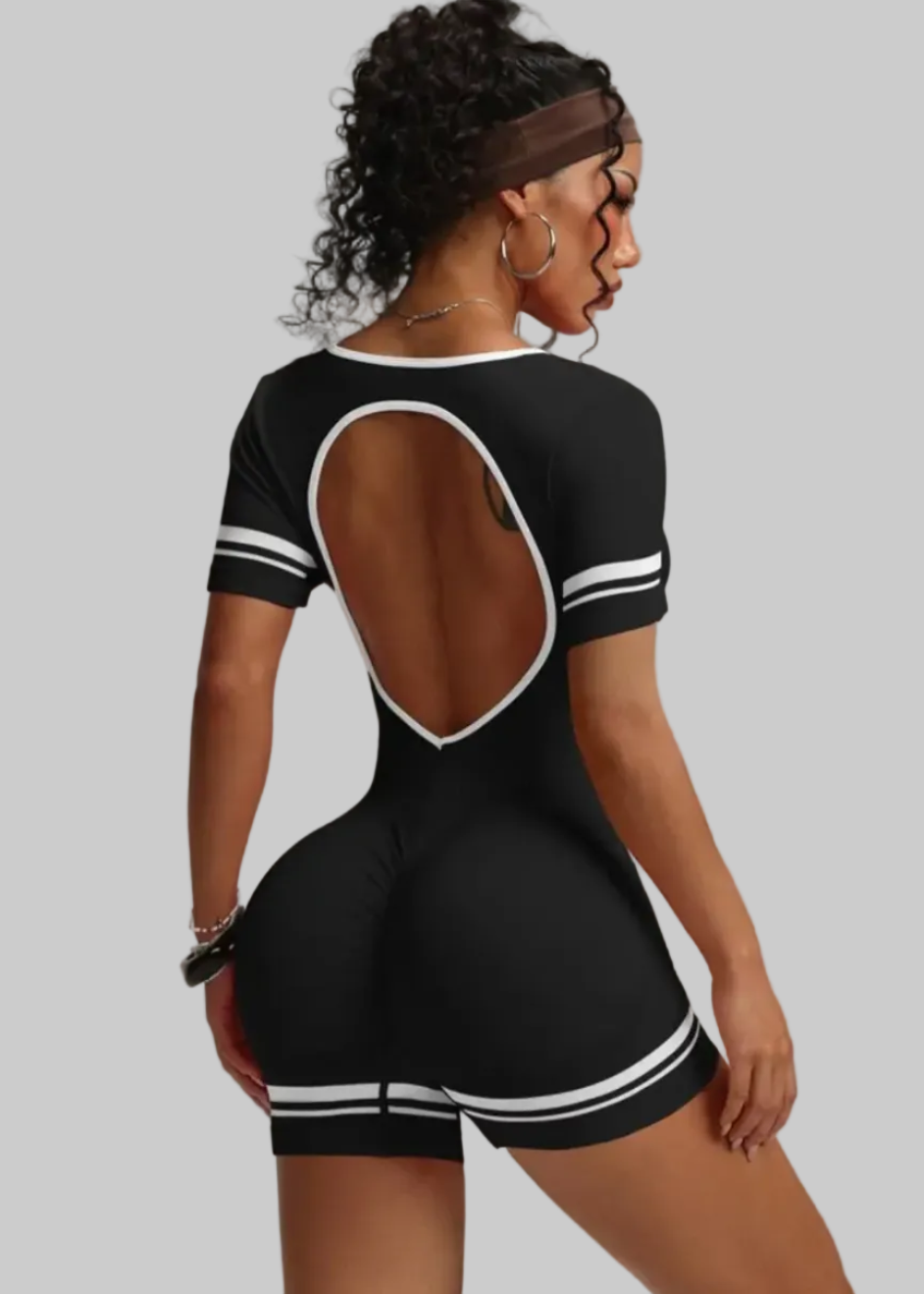 Black and white outfit with open back on a gray background