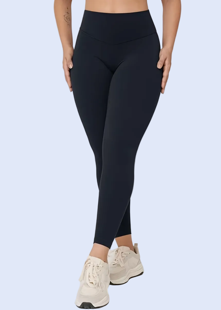 Person wearing black leggings on a white background