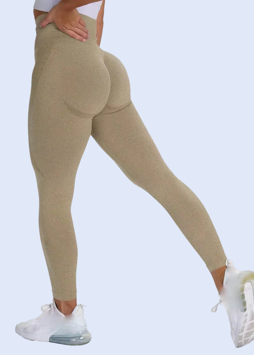 Beige leggings worn by a person on a white background