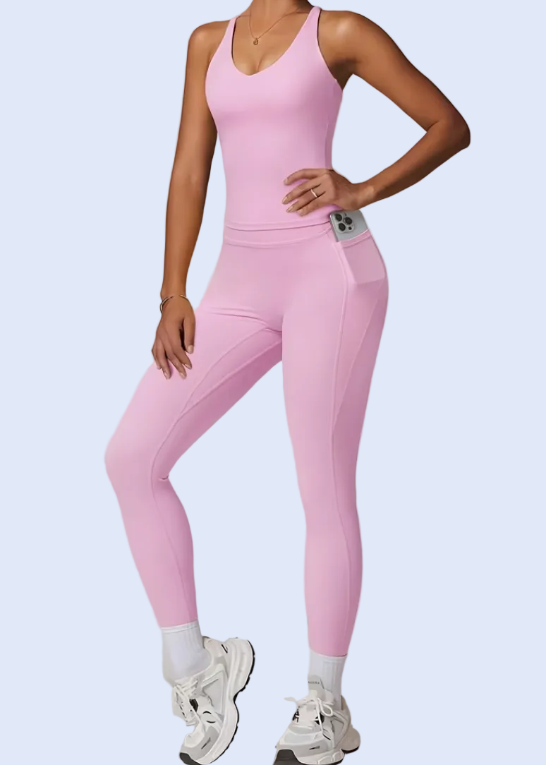 Person wearing a pink jumpsuit on a plain background