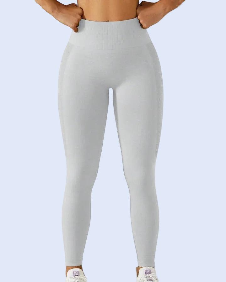 Light gray leggings worn by a person on a white background