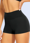 Black high-waisted shorts worn by a person on a gray background