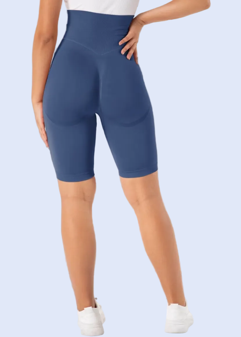 Person wearing blue shorts in a room with furniture and decor.