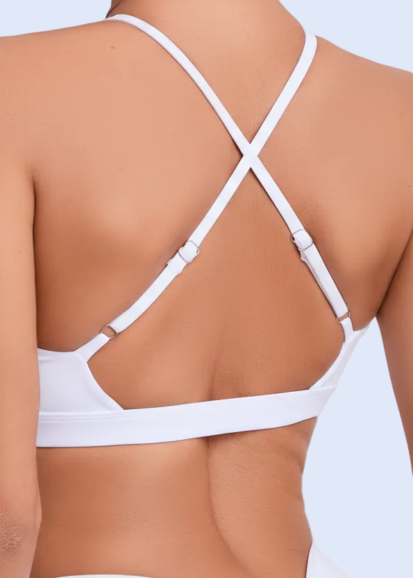 White strappy top worn by a person on a plain background