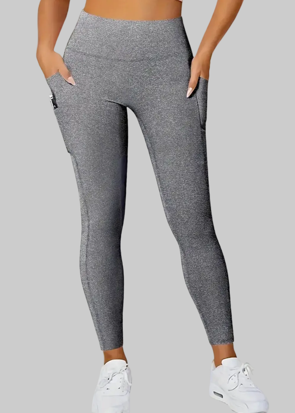 Person wearing gray leggings on a beige background